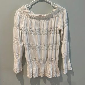 White lace embellished top with stretch neckline and cuff.